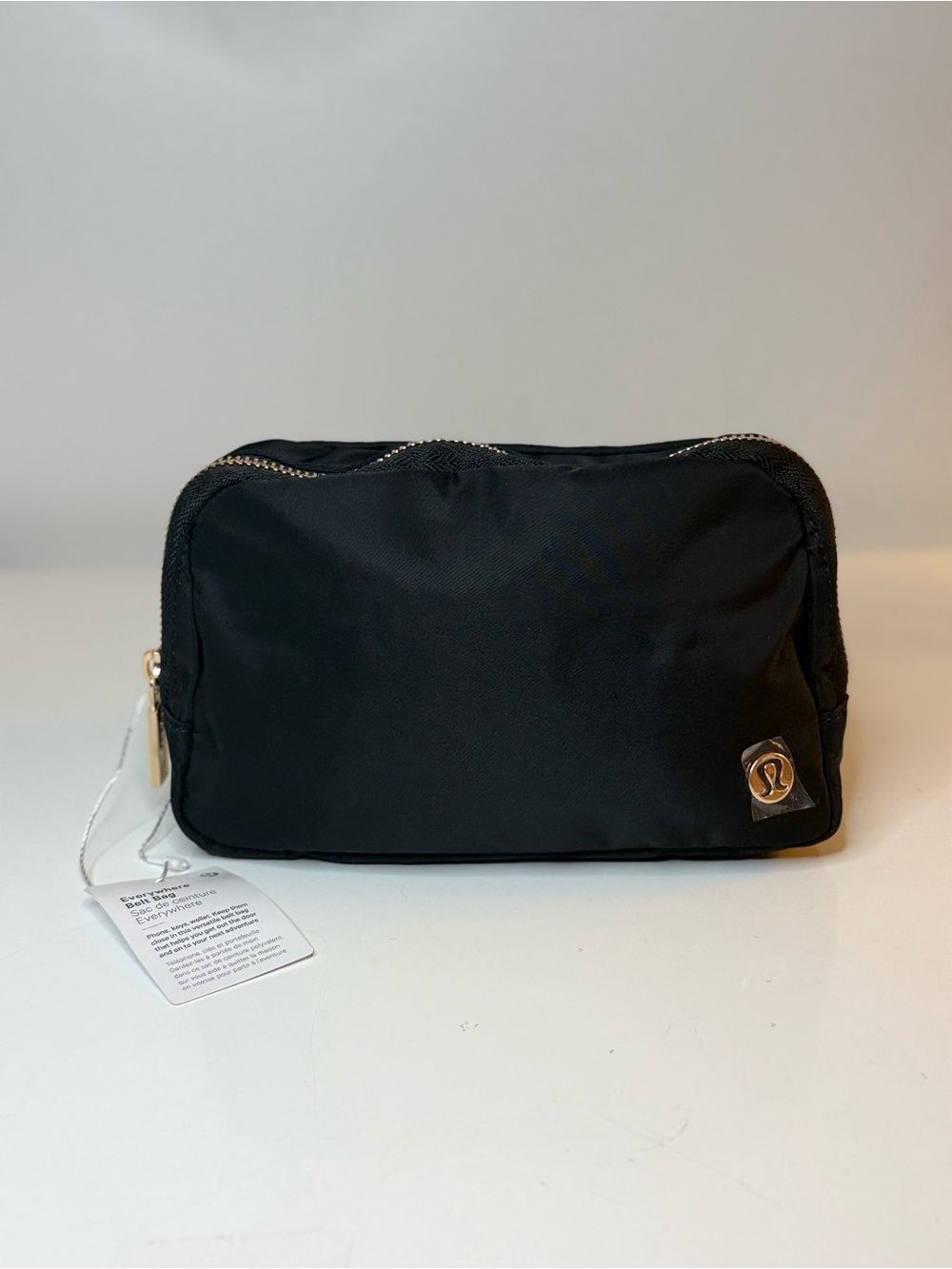 New! Lululemon Black and gold  Belt Crossbody Bag . Gold zipper.